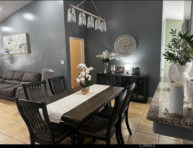 tiled dining room with high vaulted ceiling