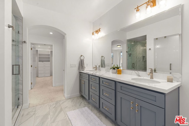 bathroom with walk in shower and vanity