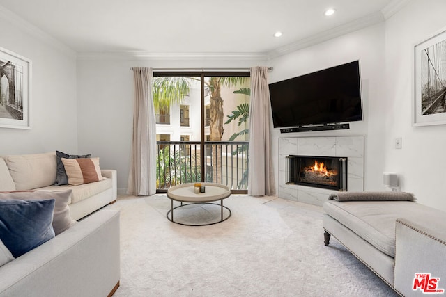 carpeted living room with a fireplace and ornamental molding