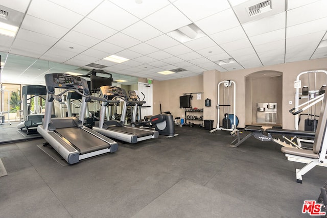 gym with a paneled ceiling