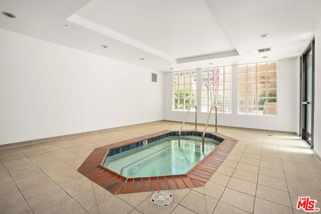 view of pool with an indoor hot tub