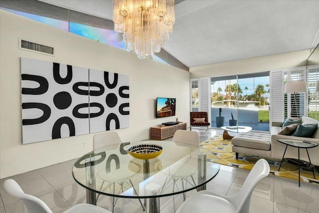 tiled dining room with a chandelier and lofted ceiling