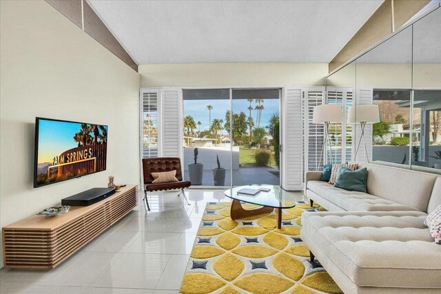 tiled living room with plenty of natural light and vaulted ceiling