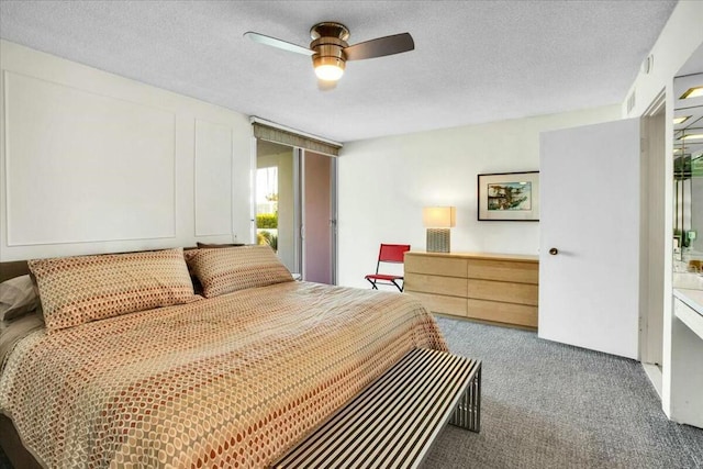 bedroom featuring a textured ceiling, carpet floors, and ceiling fan