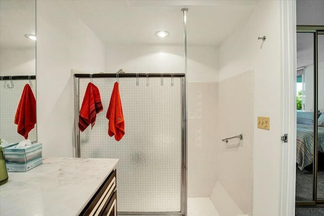 bathroom featuring tile walls, vanity, and an enclosed shower