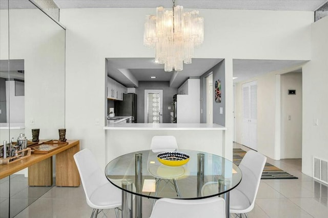 tiled dining space with a notable chandelier