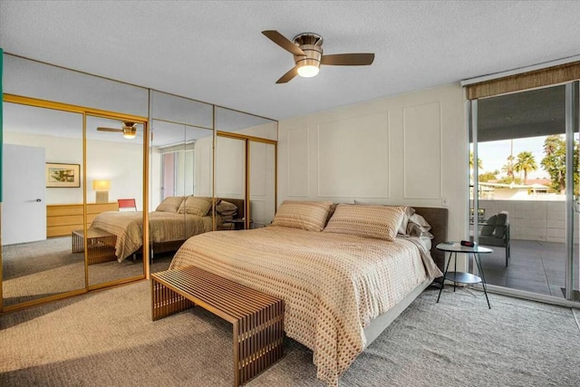 bedroom featuring ceiling fan, carpet, and a textured ceiling