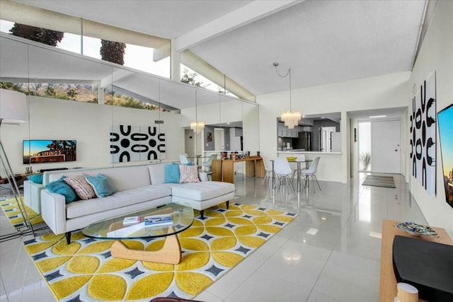 living room with a chandelier, light tile patterned floors, and lofted ceiling with beams