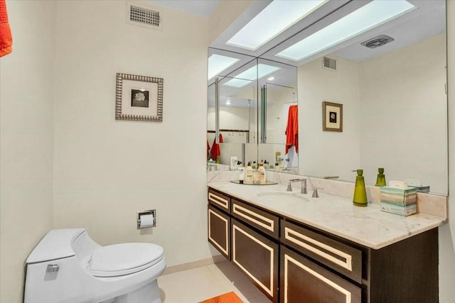 bathroom featuring tile patterned floors, vanity, and toilet