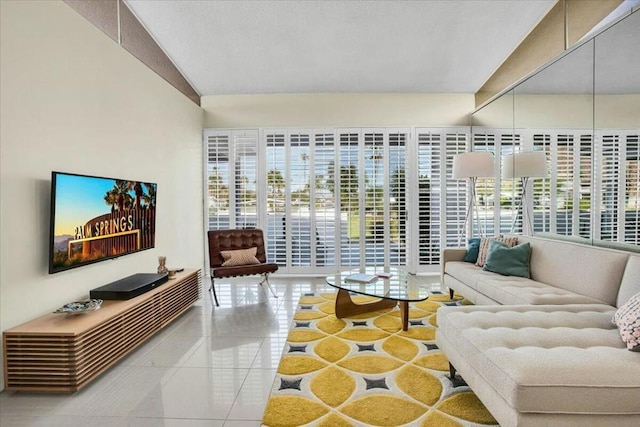 tiled living room with vaulted ceiling and a healthy amount of sunlight