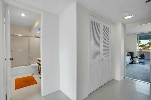 corridor with light tile patterned flooring