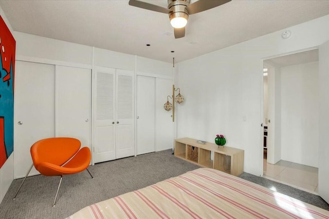 carpeted bedroom featuring ceiling fan and a closet