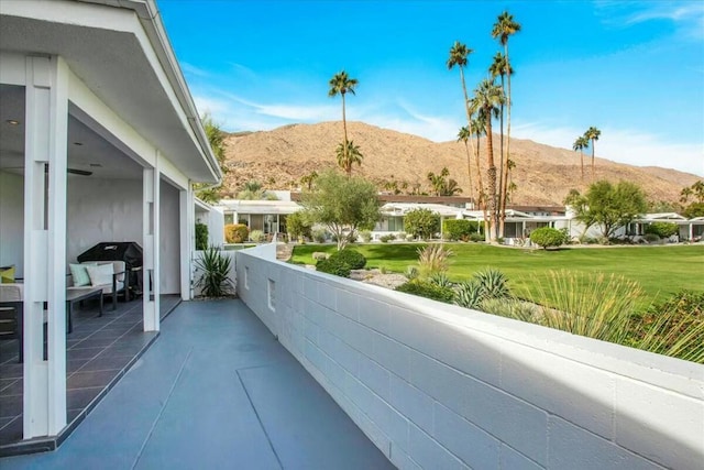 balcony with a patio area, a mountain view, and a grill