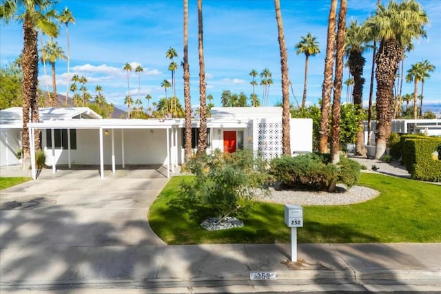 ranch-style house with a carport and a front yard