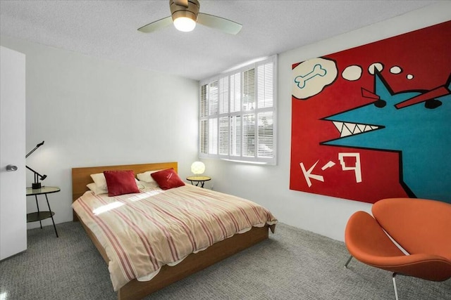 bedroom featuring ceiling fan, carpet floors, and a textured ceiling