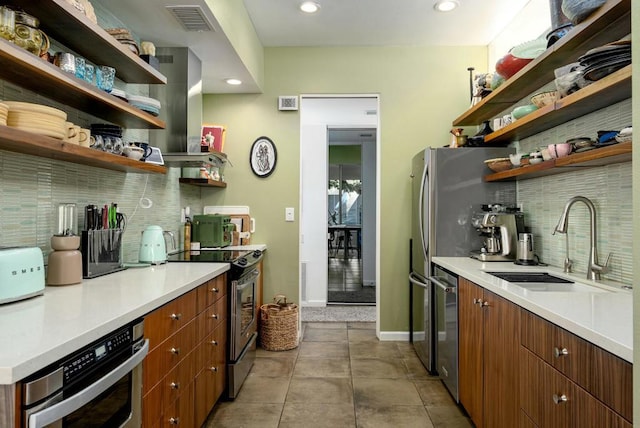 kitchen featuring sink, decorative backsplash, light tile patterned floors, island exhaust hood, and stainless steel appliances