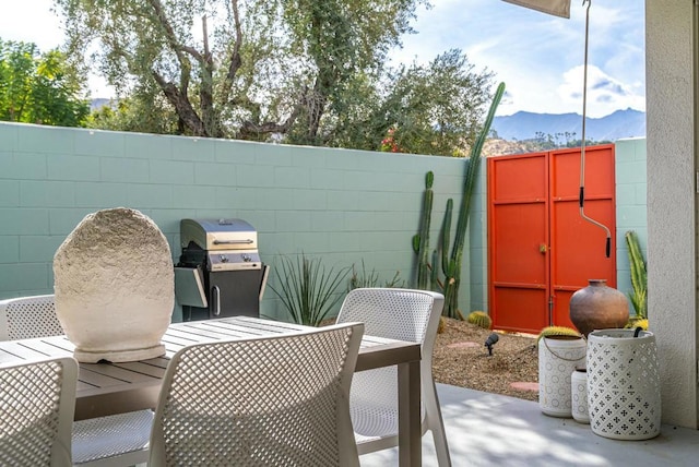 view of patio with a mountain view and area for grilling