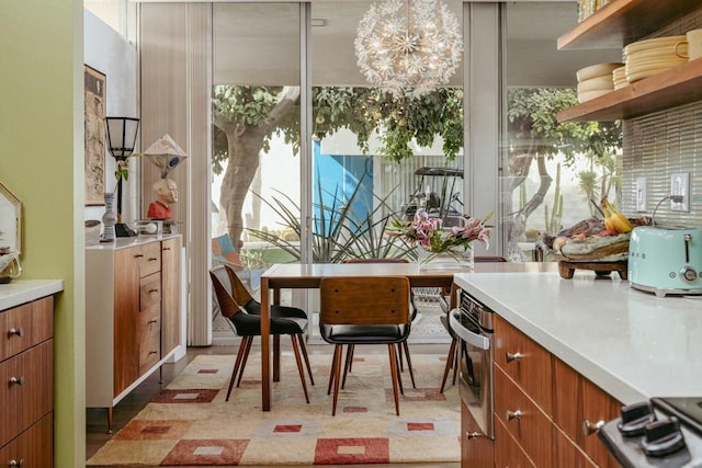 sunroom / solarium featuring a chandelier