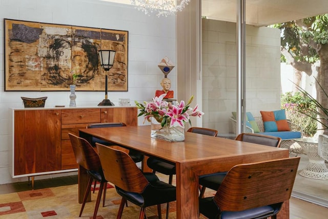 dining space featuring a notable chandelier and light wood-type flooring