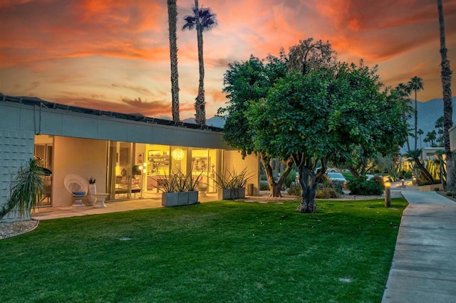 exterior space with a lawn and a patio