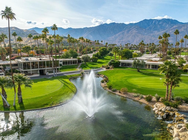 view of community featuring a yard and a water and mountain view