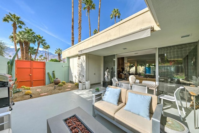 view of patio / terrace featuring an outdoor living space with a fire pit