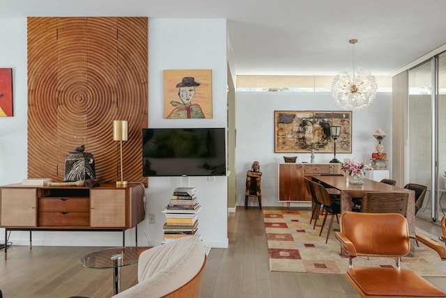 sitting room with hardwood / wood-style flooring and a chandelier