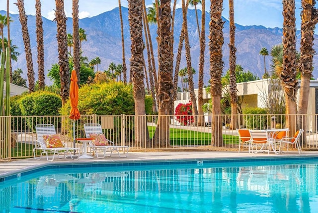 view of swimming pool with a mountain view