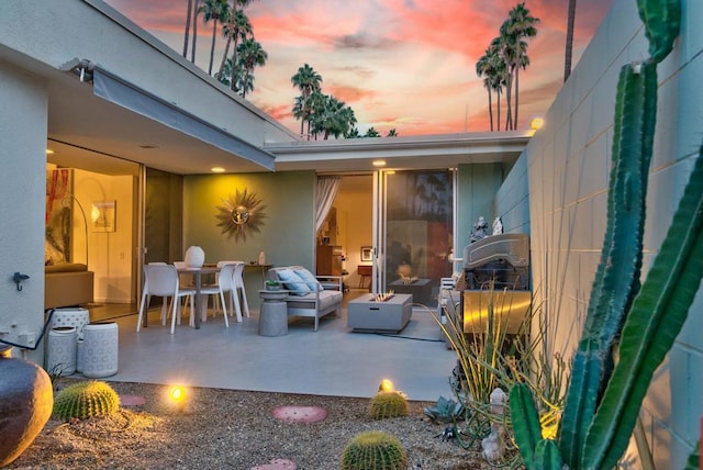 patio terrace at dusk with an outdoor living space