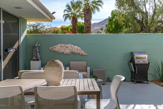 view of patio / terrace with a mountain view and grilling area