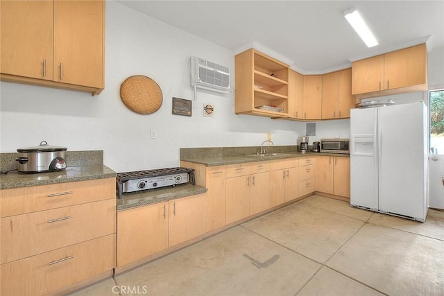 kitchen featuring light brown cabinets, white fridge with ice dispenser, sink, and light tile patterned floors