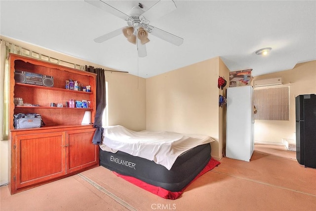 carpeted bedroom with a wall mounted air conditioner, ceiling fan, and black fridge