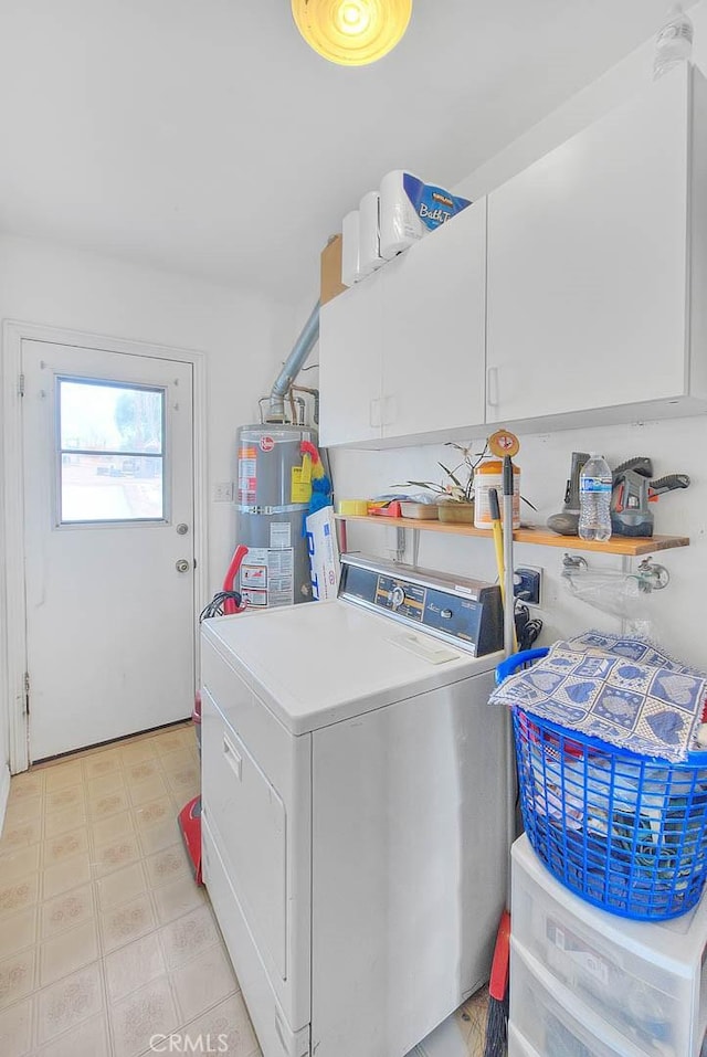 laundry area with cabinets, washer / dryer, and water heater