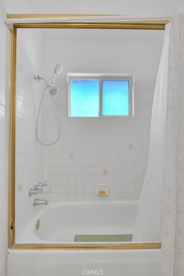 bathroom featuring shower / bath combination with curtain