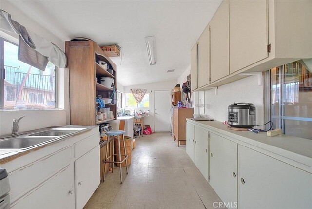 kitchen featuring sink and vaulted ceiling