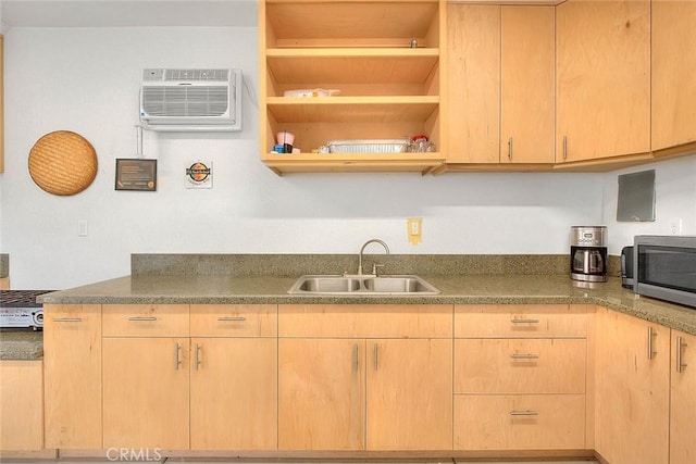 kitchen with a wall mounted air conditioner, light brown cabinetry, and sink