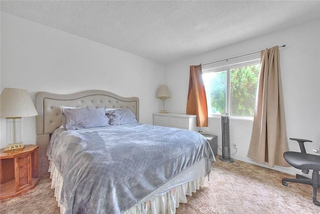 carpeted bedroom featuring a textured ceiling