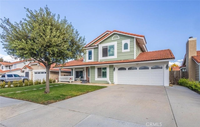 view of front of home with a porch, a front yard, and a garage