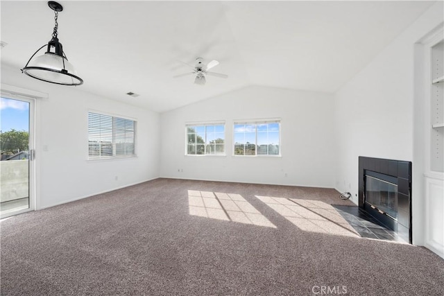 unfurnished living room featuring carpet flooring, plenty of natural light, and vaulted ceiling