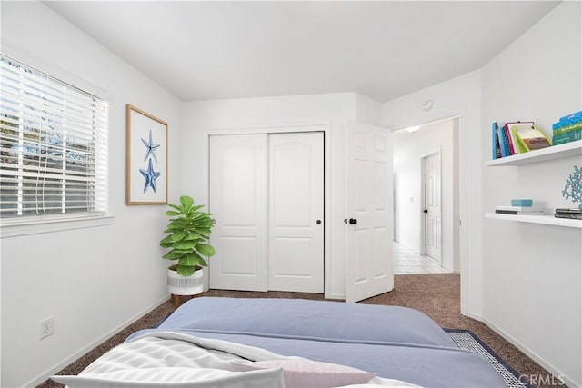 carpeted bedroom featuring a closet