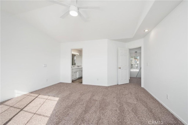 unfurnished bedroom with carpet, ensuite bathroom, and ceiling fan