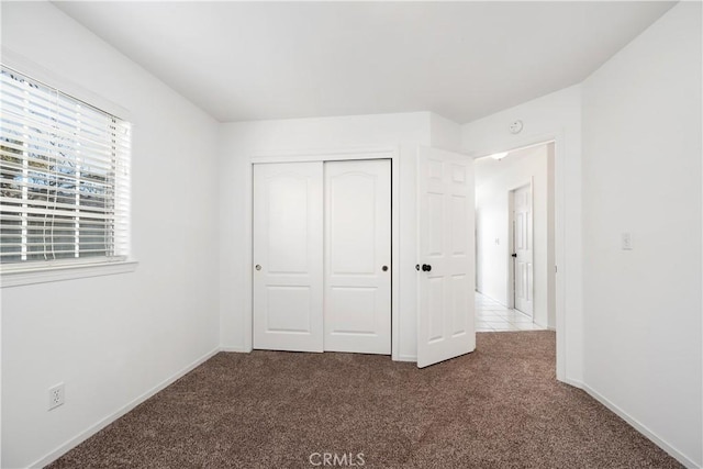 unfurnished bedroom featuring a closet and carpet