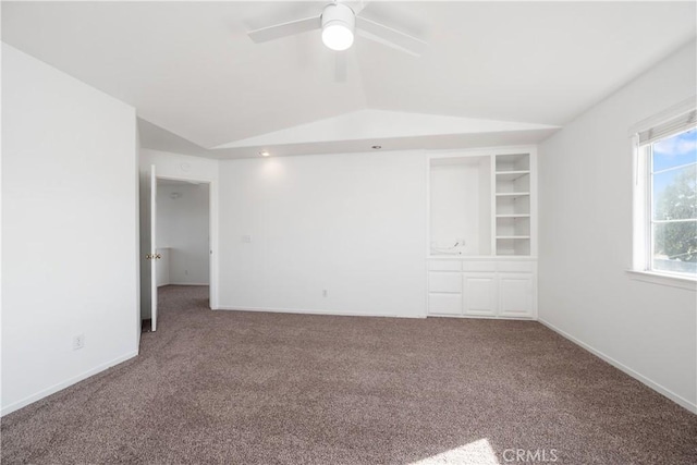 carpeted spare room with vaulted ceiling and ceiling fan