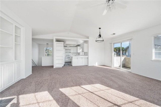 unfurnished living room featuring lofted ceiling, ceiling fan, and carpet floors