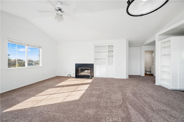 unfurnished living room with carpet, vaulted ceiling, ceiling fan, and built in features