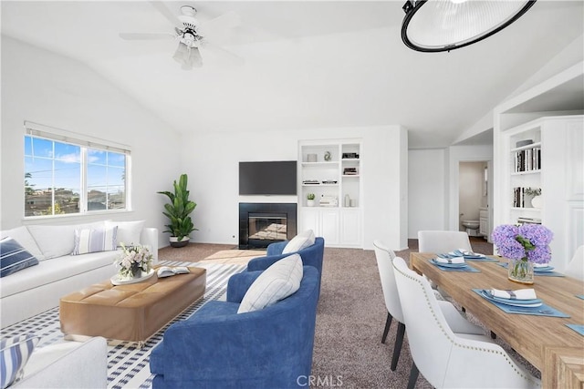 living room featuring carpet, ceiling fan, and lofted ceiling