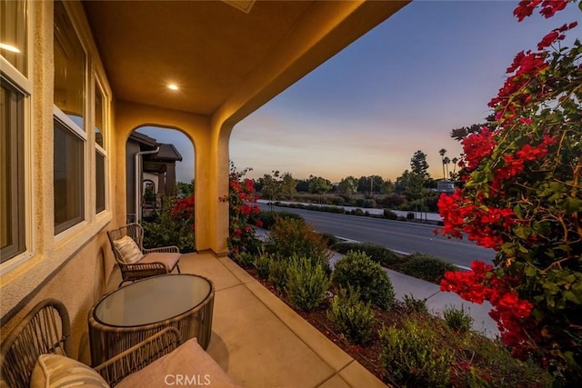 view of balcony at dusk