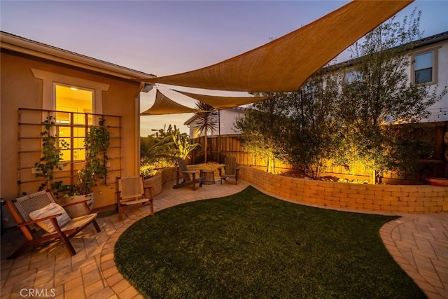 yard at dusk with a patio