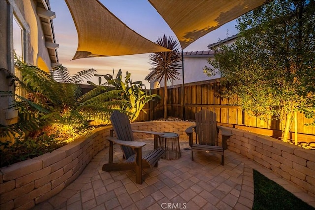 view of patio terrace at dusk