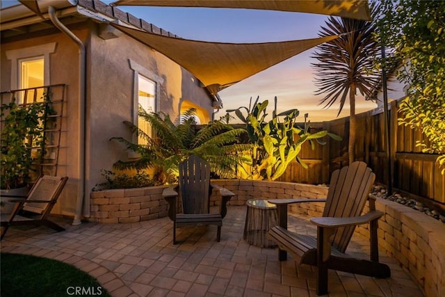 view of patio terrace at dusk